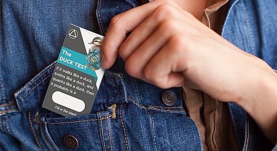 Photo of the Duck Test Card coming out of a Jean pocket